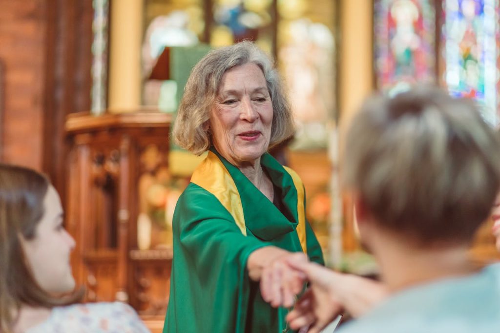 a-woman-priest-shaking-the-faithful-hand-8674842 A Woman Priest Shaking the Faithful Hand